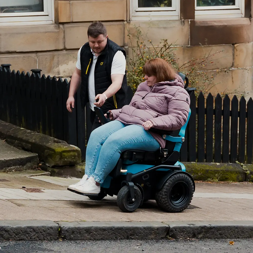 freedom-one-life-lady-in-powerchair-going-up-hill